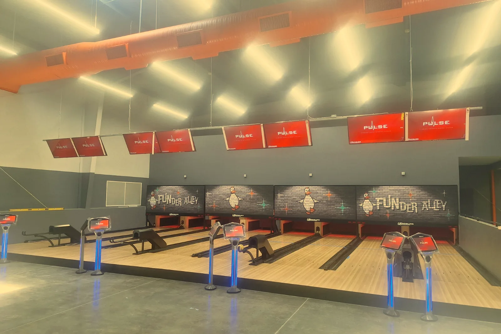 Funder Alley's duckpin lanes with FUNder Alley duck panels above the pin decks