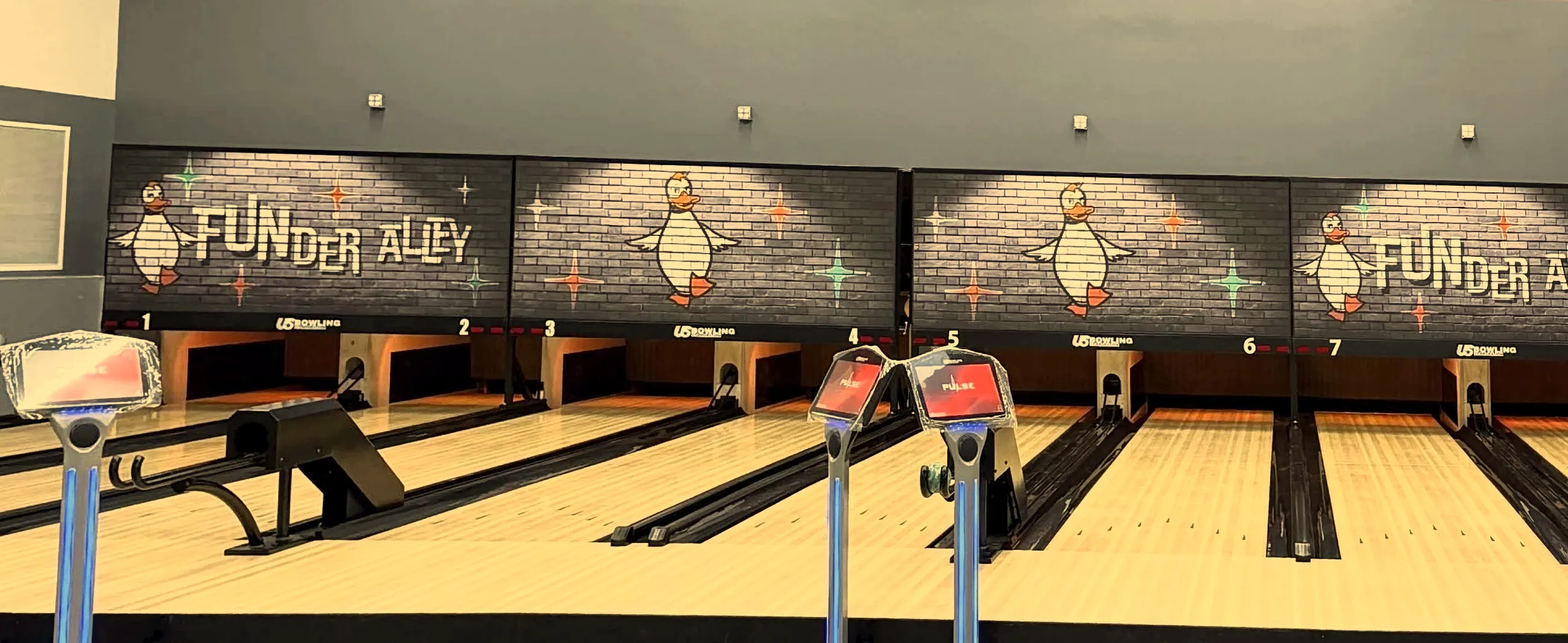 The duckpin lanes at Funder Alley with FUNder Alley duck panels above the pin decks